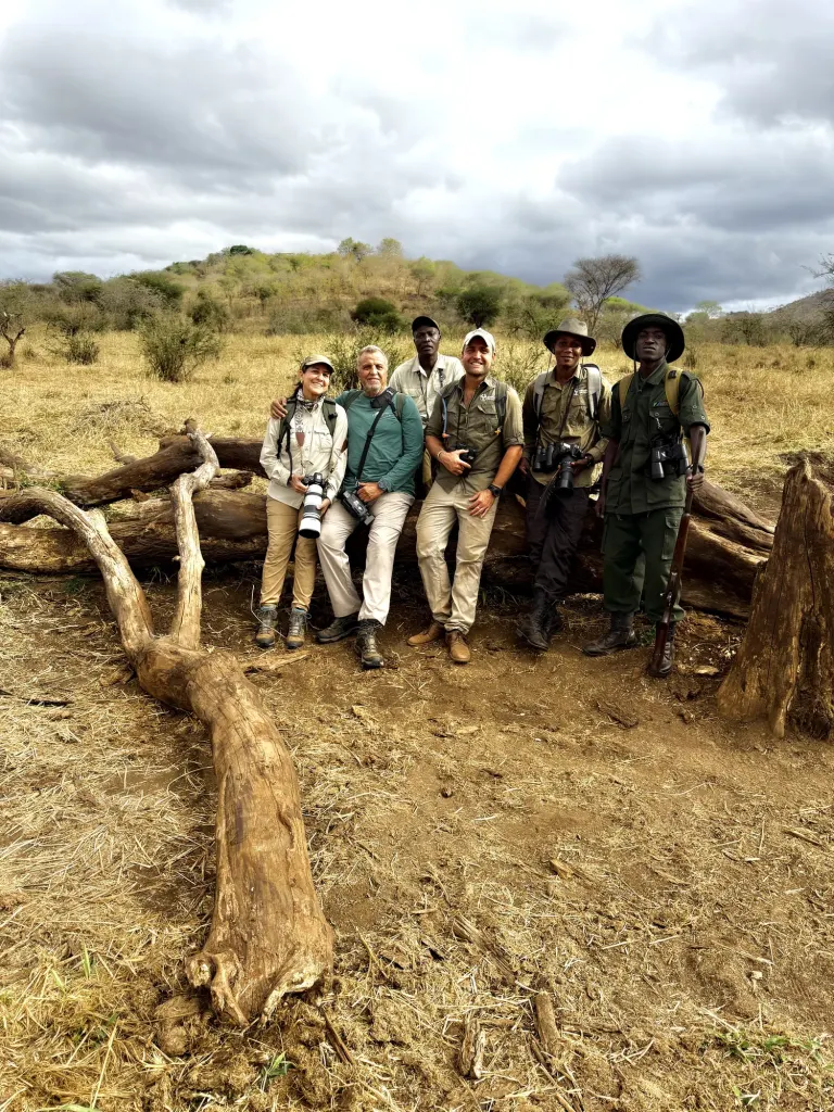 Expedition group with guides in the field at dusk