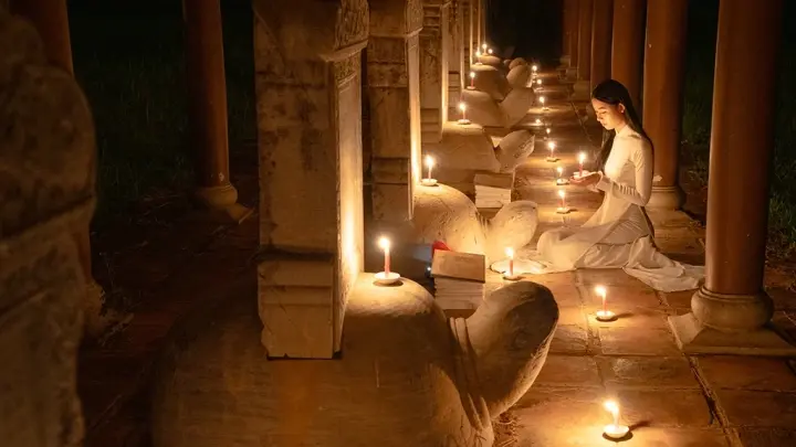 Candlelight ceremony among temple columns in Hue