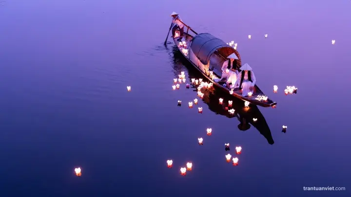 Releasing flower lanterns from a boat, photographed from above